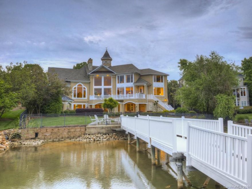 One-of-a-kind, waterfront home in The Peninsula with breathtaking floor to ceiling views of Lake Norman throughout. Gourmet kitchen, cherry hardwds, heated tile flrs, auto lighting, motion blinds, media system w/ surround sound indoor & out. 2 master suites: main & 2nd flr. Lake level living area for spectacular entertaining: rec rm w/ fpl & space for multiple game tables, media area, full kitchen, guest suite, in-ground Smart pool w/ hot tub, storage galore, private dock & fenced, private yard.