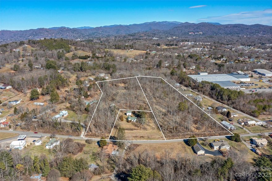 HIGHEST & BEST BY END OF DAY 10/24/2023. Family farm in popular West Asheville, last on the market in 1932, primed for development & located in one of Asheville's designated OPPORTUNTY ZONES! 10.99 acres of beautifully level land located outside the city limits with a proximity less than 5mi to DT Asheville & 2mi to the French Broad River. Endless possibilities with R-3 zoning & no zoning overlays or flood hazards. City water on-site & public sewer nearby w/MSD options identified. Property offers sprawling acreage w/mountain views, perfect for private estate, mini-farm, family compound, or maximum density development (R-3 allows for a residential district for up to 12 units per acre & a multitude of permitted uses including SF, duplexes, multi-family & more). Estate consists of 3 parcels including the original 3BR/1BA homestead, barns & garage w/bonus space above. Value IN land. Home/barns/garage sold as-is, where-is. Extensive due diligence info available for review (serious buyers)