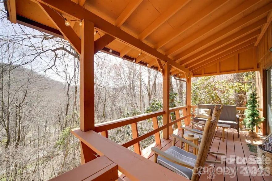 Come make your new home at Maggie Valley and see why this area is special to so many.  Entering the community as you cross over Johnathan creeks that is great for fishing, having a picnic by the river or stopping by the club house for a crafted meal.  The community offers an outside pool, Pickle ball courts, club house, Fitness center, Restaurant, Golf course, Driving Range and on site salon to get a massage.  As you enter your private parking, your  facing an east view of the mountain as your sitting on the back deck.  Open floor plan down stairs and with a gas fireplace for those cold nights.  New flooring(2022), paint(2022), new water heater(2024), carpet(2022), HVAC(2022) and exterior paint done(2024).  This home is currently on a rental program and can be your next turn key rental investment or home.(furnished) Sold AS IS.