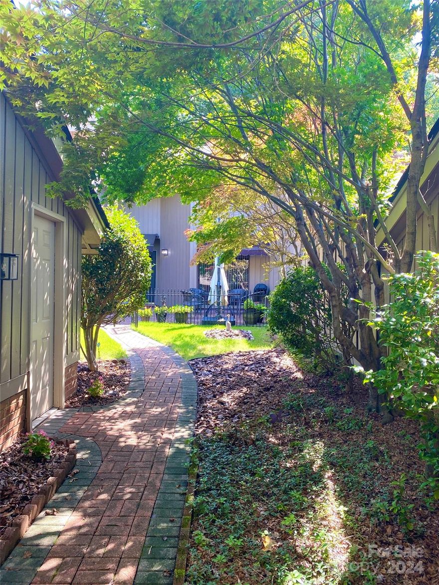 Spacious villa townhome situated in popular Carmel South subdivision. Centrally located in South Charlotte, with easy access to South Park, Ballantyne and restaurants/shops just down the road at Olde Towne Shopping Center. Gated, private front courtyard with small lawn and charming patio. Great for gardening or lounging peacefully with nature. Oversized 2-car garage. Large great room with vaulted ceilings and skylights opens onto adjoining sunroom with a private view of grass and wooded area. Sunroom also has a skylight and built-ins. Primary bedroom on main floor looks out onto courtyard, and connects to a full bathroom with large adjacent walk-in closet. Kitchen has enclosed laundry area, flat top electric stove, and has sliding glass doors leading out to courtyard patio. Upstairs, Jack-and-Jill bedrooms flank a full bathroom, and each room has a spacious walk-in closet. The second floor landing provides a view to the great room and sunroom below.