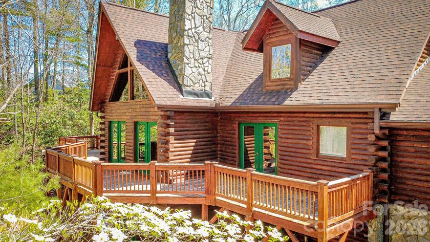 This is the mountain oasis you've been wanting! 4.75 acres just outside of quaint yet thriving downtown Marshall, where space and luxurious mountain living awaits you. The great room is highlighted by a towering stone fireplace with vaulted ceilings, the kitchen and dining is open and spacious for entertaining, and the the primary bedroom suite is on the main level. Upstairs level features a full bath and 3 bedrooms, and the finished basement has a full bar and is the dream of those who love to entertain guests! Two rooms downstairs could be used as bedrooms or offices, and each feature walkout doors. The back deck overlooks a mountainous, wooded terrain, and the private, covered front porch is graced by the presence of flowers and other flora native to the North Carolina mountains. This home is one-of-a-kind and epitomizes mountain living -- schedule a showing!