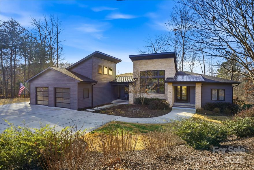 Tucked away on a private corner lot in the heart of Lake Norman, this exceptional modern residence sits on over 1.5 acres with breathtaking lake views and no HOA. Thoughtfully designed for both everyday living and elevated entertaining, the open-concept layout showcases a stunning chef’s kitchen anchored by an oversized marble island, custom cabinetry, a spacious butler’s pantry with breakfast bar, and an integrated wine fridge.
The home is rich with high-end upgrades, including smart sun windows and sliders, an Aerus air scrubber with whole-home humidification system, and a whole-house water filtration canister. A temperature-controlled, encapsulated crawl space provides abundant, clean storage rarely found at this level.
Step outside to your private outdoor retreat featuring a resort-style saltwater pool, travertine decking, outdoor kitchen, and outdoor shower; perfect for entertaining or unwinding year-round. The oversized primary suite offers generous proportions and exceptional storage, creating a true sanctuary.
Additional highlights include a spacious two-car garage with built-in utility storage, expansive living areas flooded with natural light, and seamless indoor-outdoor flow designed to maximize the Lake Norman lifestyle. A rare opportunity to own a private, modern estate combining luxury, functionality, and breathtaking surroundings.