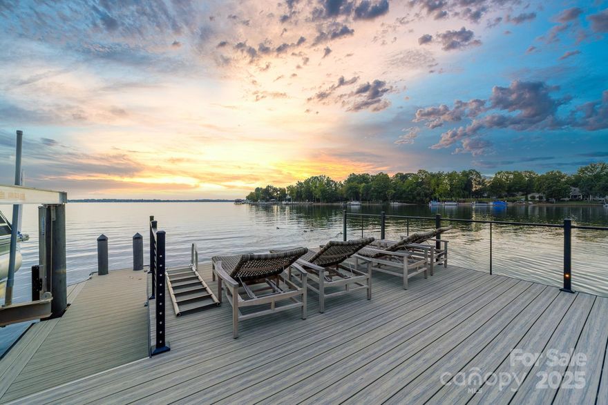 Poised on the shores of Lake Norman in The Point, this extraordinary waterfront residence blends timeless architecture with modern sophistication. A beautifully landscaped lot frames sweeping long-range views, while the backyard reveals a private retreat with a saltwater pool & spa, fenced lawn, sandy beach with fire pit, fresh-water outdoor shower, outdoor dog wash & outdoor grilling area. The expansive dock, recently rebuilt, features a 17,000 lb lift, 50 amps of power & lake-fed irrigation. Inside, a grand two-story foyer opens to a living room with coffered ceiling, fireplace & walls of glass capturing the lake. The gourmet kitchen showcases a massive quartzite island, Sub-Zero 66” fridge/freezer, Wolf range, wine & beverage fridges & reverse osmosis filtration. The main-level primary suite offers lake views, tray ceiling, dual walk-ins & a spa-inspired bath. Upstairs, four gracious en-suites, a flex room with fireplace & laundry provide balance. White oak floors, custom millwork, Hunter Douglas shades, Denon sound system, epoxy garage, instant tankless water heater, encapsulated crawlspace, home generator & whole-house water treatment complete this remarkable home.