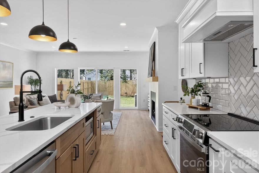 Now presenting 1802 Vinton, an interior-unit townhome offering a thoughtful take on urban city living. With clean design and comfortable finishes throughout, this home balances style and functionality in an easy, livable way. Inside, you’re welcomed by a light-filled entry and a practical layout designed for everyday flow. The kitchen anchors the main level with quartz countertops, an oversized island, stainless steel appliances, and a walk-in pantry with custom shelving. It opens directly to the living area, creating a natural space to gather or unwind. Luxury vinyl plank flooring runs throughout, adding a cohesive feel, while the living space extends to a private, fenced outdoor area, a rare find for city living and perfect for low-maintenance outdoor enjoyment. Upstairs, all three bedrooms are well-positioned, including a spacious primary suite with a walk-in closet and a spa-inspired bath. Located in a highly convenient pocket of the city, you’re just an eight-minute walk to Oaklawn Language Academy, minutes to Camp North End, two minutes to JCSU, and close to the Gold Line, Uptown, and I-277. Priced at $585,000, with eligibility for 100% financing with no PMI, plus up to $10,000 in lender assistance with the use of a preferred lender. The builder is also offering up to $5,000 in closing cost contributions with an acceptable offer and the use of the preferred lender. Approachable, well-located, and modern. Welcome home.