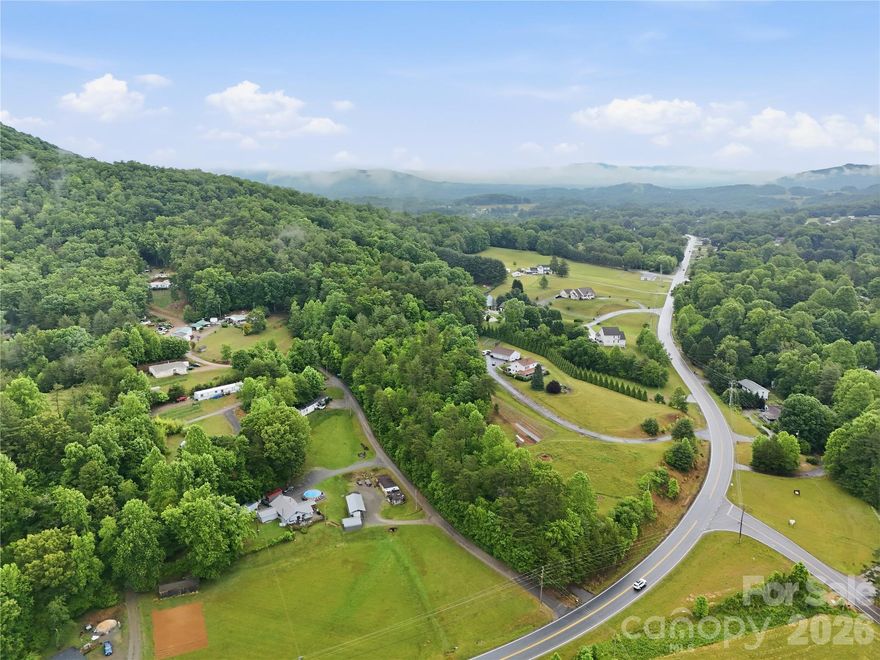 Beautiful 11.10-acre tract located in the desirable Upper Hominy area of Buncombe County. This primarily wooded property offers excellent potential for development, a private mountain estate, or your dream home in the mountains. With Open Use zoning and no known restrictions, the possibilities are wide open. The land features sloping wooded terrain, natural privacy, and potential mountain views with selective clearing. Road frontage is located along Pisgah Highway; however, a road or driveway will need to be installed for access into the property. Conveniently situated in a peaceful rural setting while still being within reach of Asheville, Candler, Waynesville, shopping, dining, and outdoor recreation. A rare opportunity to own a sizable unrestricted mountain parcel in a beautiful part of Buncombe County.
