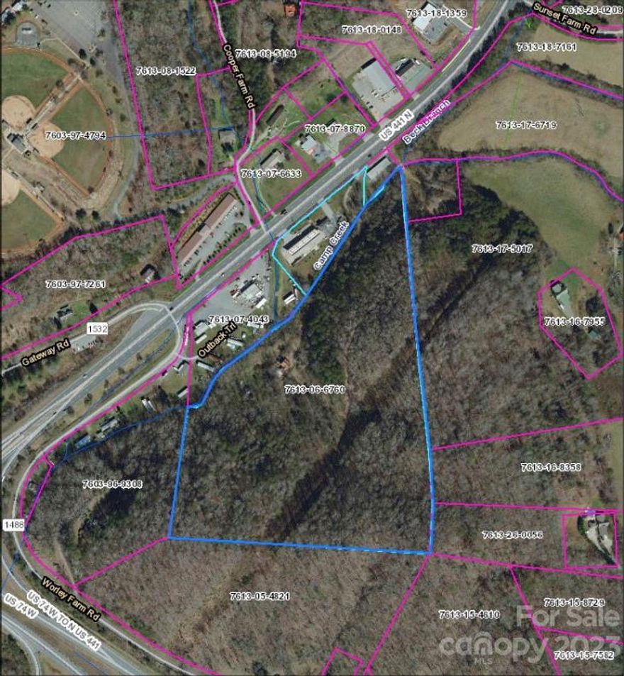 Don't miss this versatile development opportunity with arterial access to the US-441 and Great Smoky Mountain Expressway tourism corridors! The property benefits from liberal zoning, TWSA infrastructure access, access drive, and an as-is homesite in the center of the property. Boundaries extend to the ridgeline, offering a private setting for single family residential, multifamily, agriculture, or other uses. The lower property boundary includes a flowing mountain creek. All considered, this central and accessible property offers an excellent opportunity to realize your vision.