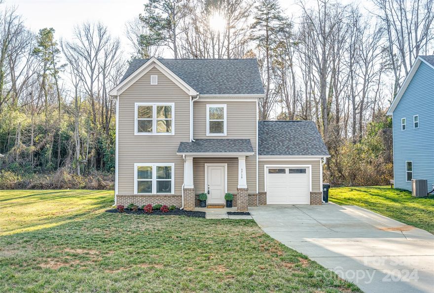 Constructed in 2019, this stunning two-story residence showcases a wealth of upscale amenities and is ready for immediate occupancy! With 3 bedrooms, 2.5 bathrooms, and a seamlessly designed open floor plan, this home stands out with 9-foot ceilings on both floors. The contemporary layout is enhanced by stylish vinyl plank flooring throughout. The well-appointed kitchen boasts stainless steel appliances, granite countertops, and a generously sized central island. In the primary bedroom, tray ceilings and designer lighting create an elegant ambiance, complemented by an attached deluxe bathroom featuring a glass-enclosed shower, dual vanity sinks, and a spacious walk-in closet. The inclusion of spray foam insulation ensures energy efficiency, promoting both cost savings and comfort. The absence of an HOA provides the perfect finishing touch to this exceptional residence.