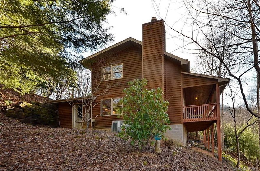 Enjoy the mountain view and summer shade in this incredible home which features 19' cathedral ceiling, open floor plan with fireplace, spacious kitchen with island, master on main, open loft area, large covered front deck and single car garage, all with easy year round paved access.