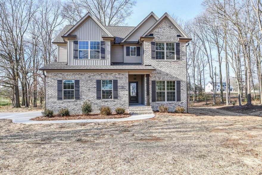 Hurry to see this New Construction Home! This beautiful home in the Piedmont school district sits on a private partially wooded lot. It offers a private rear covered porch with tongue and groove wood porch ceilings (front & back porch). The Kitchen offers white shaker style cabinets, a large breakfast bar, with a subway tile backsplash, L4 granite countertops throughout, upgraded plumbing & light fixtures, an abundance of recessed lighting, Master Bedroom on the first floor with custom closet shelving, Master bath with a tiled shower (tiled shower floor & tile deco accent) and a standalone tub, an eye-catching two-story Great Room with a stone covered gas fireplace,  beautiful Revwood wood flooring, ceramic tiled bath floors, loaded with trim throughout, framed bathroom mirrors, additional three oversized bedrooms upstairs with their own walk-in closets, whole house water filtration system, upgraded 50-year architectural shingles, this home has all the extra touches you would desire!