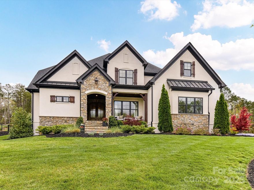 Looking for luxury in Fort Mill? Look no further! Welcome to this fabulous 5bd/4bth home in The Ridge at Fort Mill, where elegance and comfort blend seamlessly on a 1+ acre lot. With over 4,100 sq. ft. this custom-built luxury property features vaulted ceilings with accented beams, an open-concept design that’s both inviting and functional, and a can't miss ceiling detail in the kitchen! Designed for both entertaining and everyday living, the chef’s kitchen boasts Sub-Zero/Wolf/Cove appliances, an oversized island, and scullery. The owner’s suite offers a serene escape with a spa-like primary bth, soaking tub, and expansive walk-in closet. Step outside to your personal paradise, featuring a covered porch with retractable screen, fireplace, and overhead heaters for year-round comfort. The saltwater pool/spa, outdoor kitchen, and shower complete this exceptional outdoor retreat, all set within a fully fenced and beautifully landscaped backyard. This is more than a home—it’s a lifestyle!