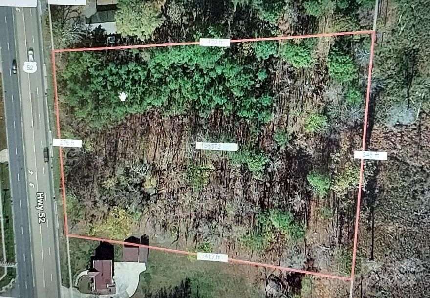 HIGHWAY 52  N in fast growing City of  Albemarle. 3.13 Commercial acres! Raw land , water  is available , at center of highway , sewer runs  right in front of the property.  Many commercial uses are allowed here in the City  Business District.  Automotive , Retail ,  Hotel, Vet office ,Bank site , and many more!  No residential homes allowed , and NO  min sq feet to build.  65 foot height limit , setbacks are 30 front , 10 sides and 20 back. Great location, growing area! Wooded , treed lot.
