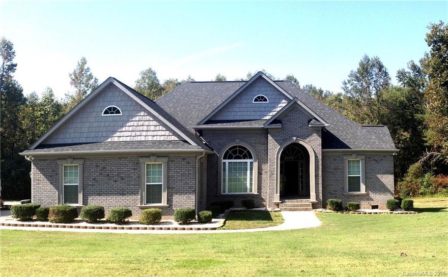 Stunning home on private 3 acre lot on dead end street in rural subdivision. Most homes in neighborhood are 2-5 acre lots. Beautiful mix of grey brick with stucco accents with arched entrance. Interior has hardwood floors, SS appliances soaring ceilings w/ recessed lighting, triple trey ceiling in Master BR. All rooms and closets have heavy 4" crown molding that really gives it a beautiful finished look. Archway entrance door and Arched entrances to Great Room and dining room is very stunning.