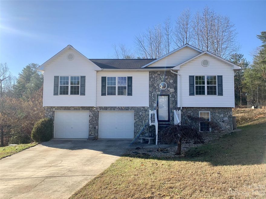 Make your New Year's resolution a reality! Become a homeowner in 2024 with this lovely home in quiet neighborhood with beautiful views. This home is one of the largest models in the subdivision. Split bedroom floor plan with main floor laundry. No going out to the garage! Large, oversized 2 car garage. Custom stone steps leading to front door. Step outside the french doors to the large deck on rear of home with Trex steps. Radon mitigation system installed. Basement has been painted and has flooring installed and could easily be finished or use as is as a craft room, play room, or any other purpose you desire. Less than 10 minutes to picturesque Lake James, 15 minutes to Historic Downtown Morganton. Make it your own today!