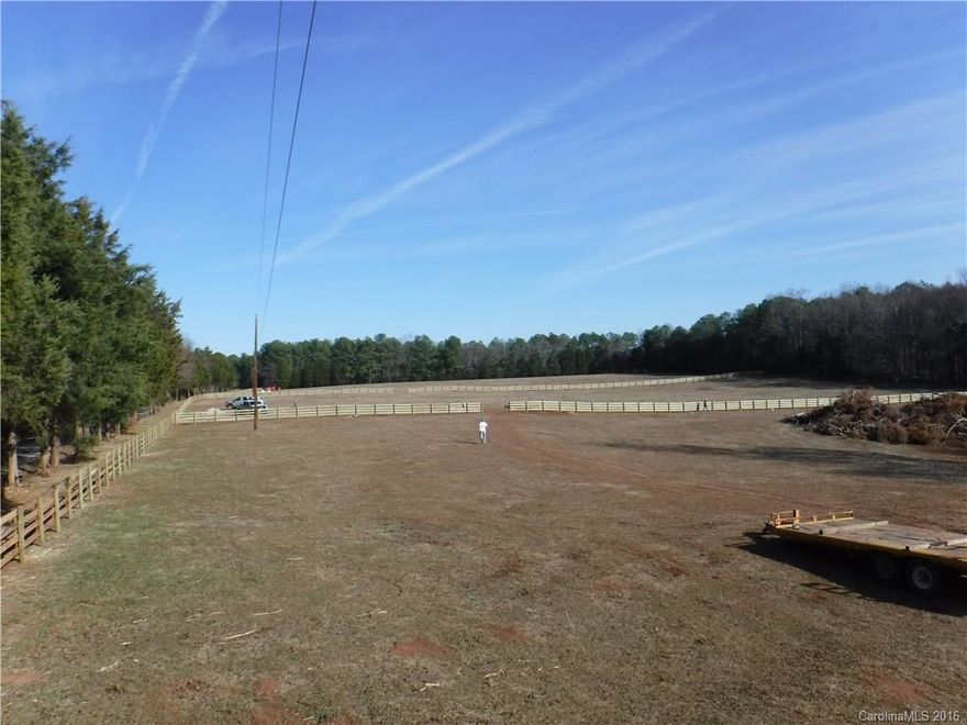 Beautiful setting ready for your dream home. See the individual entrances wired for light, 4 plank horse fencing surrounds 3 sides of the 5 acres. Any added fencing must match existing fences. Well and Septic required.