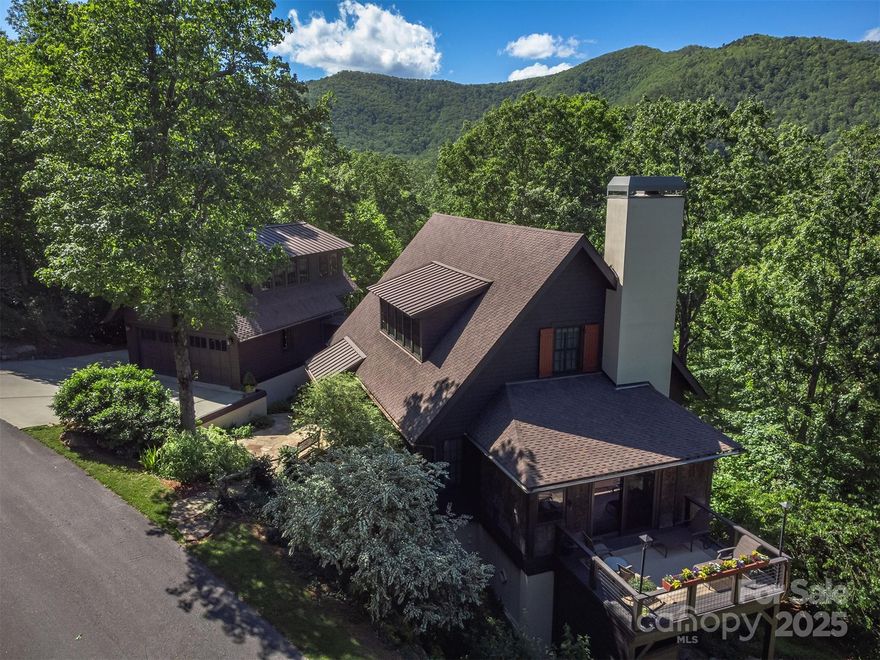 Nestled in desirable Montreat, 285 Chapman Road offers 4185 SF of refined mountain living in Mountain Vernacular style. Built in 2009, this 5-bed, 5.5-bath home features a geothermal HVAC system, whole-house Sonos® audio, premium PlyGem® Mira windows, and an automatic 20kW Generac® generator. Large living space and kitchen plus second living area/private gym on the lower level. Enjoy energy efficiency with open-cell foam insulation and a HERS rating under 50. The main home includes a wood-burning fireplace, long range mountain views year-round, abundant outdoor living space. A private suite over the two car garage includes a wet bar and separate HVAC, ideal as an office or guest space. Relax outdoors with a cedar-lined sauna, Caldera® hot tub, and cold plunge. Located within the Vista at Montreat community, this well-maintained property offers guest parking, privacy, and exceptional craftsmanship throughout—all just minutes from Black Mountain and Montreat's extensive trail system.