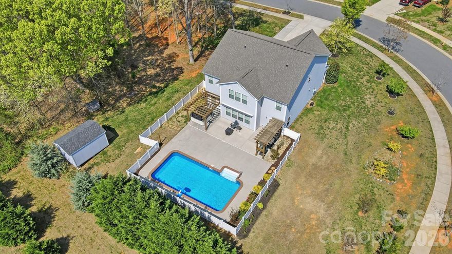 If you've been settling for a backyard, this isn't that. This 4 bedroom, 2.5 bath home on a private 0.8-acre corner lot in Midland was built for people who actually use their outdoor space – a fenced in-ground pool, dedicated outdoor kitchen area under a pergola, hot tub under its own covered structure, and a retractable awning extending the living area off the back of the home. It's a full outdoor setup that would cost well over $100K to replicate.
Inside, 3,147 sq ft of well-proportioned living space gives you room to breathe – open main level with kitchen island, pantry, and French doors, plus four bedrooms, a bonus room, and laundry upstairs. The 2-car garage and expanded driveway handle up to 6 vehicles with ease. What makes this lot rare is the wooded buffer along the side – a natural privacy screen you simply don't find on newer construction. Fruit trees, large storage shed, and updated landscaping round out a property that functions like a private retreat while sitting minutes from shopping, dining, and Cabarrus County's well-regarded schools. Pre-inspected, warranted through 2-10, and priced with serious buyers in mind. Come see what $599,000 actually buys in this market.