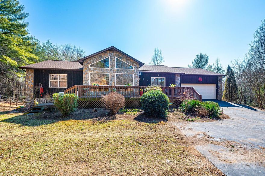 With many wonderful features this home esthetically blends into the wooded surroundings with a cedar wood exterior and stone features, a front porch and a deck on the back.  You are greeted with beautiful vaulted, beamed wood ceilings and a floor to ceiling see through stone gas fire place and large windows offering lots of natural light when you enter the home. A dining room is on the other side of the fireplace with an entrance onto the back deck.  Located off the dining room is the kitchen making entertaining a convenience!  With the split floor plan you find a bedroom, guest bathroom with a double vanity and a bonus room on one side of the home with the large primary bedroom with attached bath and walk-in closet and direct access to the front porch located on the other side. The unfinished basement with 9' ceilings is potential for additional living space to be added.  A mud room/laundry room is located off the attached 2 car garage. Beautiful home in a convenient location!