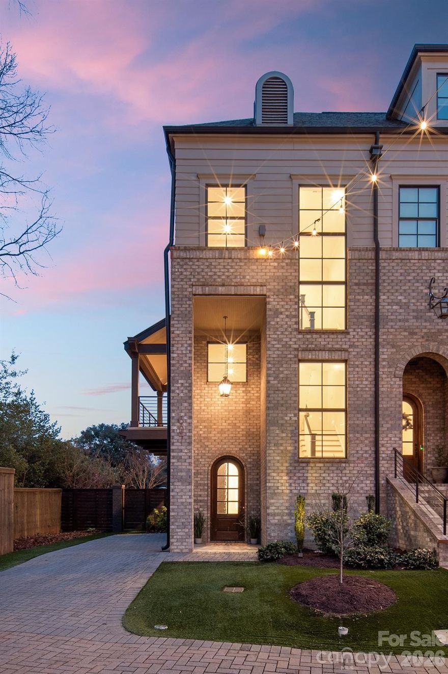 Exceptional end-unit townhome in Elizabeth/The Towers at Mattie Rose delivering an elevated, lock-and-leave lifestyle with striking architectural presence. Built in 2019, this three-level residence offers 3 BR, 2.5 BA, and approx 2,432 SF thoughtfully designed for modern living with intentional separation of spaces. The main level impresses with an airy open-concept layout featuring a statement gas fireplace, expansive island, pantry storage, custom banquette seating, and abundant natural light ideal for entertaining. Refined interiors showcase wood flooring, high ceilings, designer lighting, and curated finishes throughout. The primary suite occupies its own level with a sitting area, spa-inspired bath, walk-in closet, and private covered balcony. The upper level includes two additional bedrooms, full bath, laundry, loft, and versatile flex spaces suited for office or media use. Outdoor living is elevated with a private paver patio, low-maintenance turf yard, wood privacy fencing, and an additional balcony. Two designated parking spaces, HOA-maintained exterior, and close proximity to Independence Park, Little Sugar Creek Greenway, Uptown, Plaza Midwood, and Midtown complete this exceptional offering.