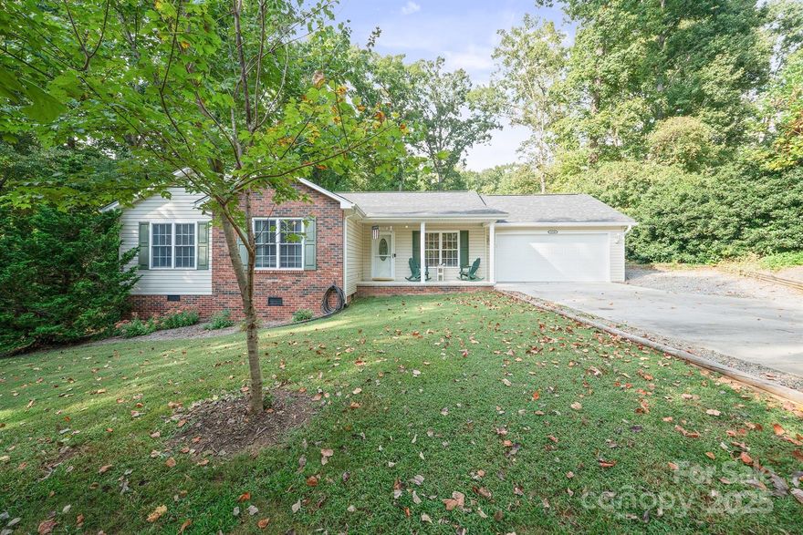 Welcome to this beautifully maintained 1-level home with gorgeous modern updates, and a peaceful country feel-all just 5–10 minutes from retail, grocery stores, and dining. Built in 2006 and offering approximately 1,588 square feet of living space on a spacious 0.47-acre lot, this 3-bedroom, 2-bathroom home is truly move-in ready and loaded with features. Enjoy the charm of a brick and vinyl exterior with mature trees around, offering a woodsy, serene atmosphere. The home has a new roof (2024), new garage door and opener (2024), new gutter guards (2025), and fresh paint throughout the entire interior and garage, making it feel like new.
Step inside to find pre-finished hardwood flooring throughout the living areas & bedrooms, vinyl plank flooring in both bathrooms, & ceramic tile in the laundry closet. The spacious living room features a gas log fireplace  (sellers do not use, no propane tank on site) & a remote-controlled ceiling fan with light, adding convenience. All 3 BRs are generously sized & include ceiling fans with lights, and the owner's suite offers a walk-in closet and a private bath with double sink vanity, tub/shower combo & linen closet. The home has lots of closets and storage space thruout. The kitchen is fully equipped with appliances included—refrigerator, range, microwave, and dishwasher—making this a truly turnkey property. Relax on the covered front porch or enjoy evenings on the freshly painted back patio overlooking a huge fenced backyard complete w/a fire pit area, perfect for entertaining or enjoying the peaceful surroundings. This property offers the best of both worlds — a quiet, natural setting with the convenience of nearby amenities. With thoughtful updates and quality features throughout, this home is perfect for buyers looking for comfort, space, and value. NO city taxes!