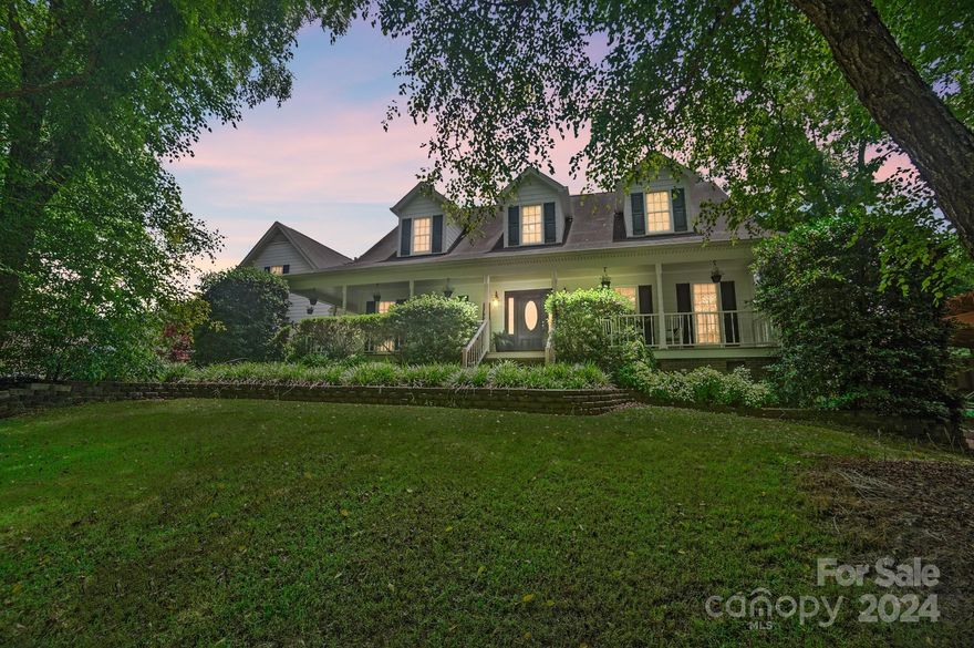 Nestled on 10 picturesque acres, this charming property welcomes you with a gorgeous tree-lined asphalt driveway, crossing a small creek and featuring an electric privacy gate. Natural privacy is provided by Leyland Cypress, pear trees, and holly bushes.

Enjoy the Southern-style wrap-around front porch, brick pavers, and a large two-story family room with a cozy fireplace and stunning views. The kitchen boasts a gas stove, breakfast area, and dining room. The main level includes a primary suite and laundry, while upstairs offers spacious bedrooms and a recreational area with plumbing for future use.

The home features James Hardy siding, a whole-house generator, three central air HVAC units, and a mini-split unit for the garage. Additional amenities include a tractor shed, storage shed, blueberry bushes, canna plants, & a garden area.  The property also has a small unfinished basement.
The radio towers will be removed before closing.

Be sure and check out the video.