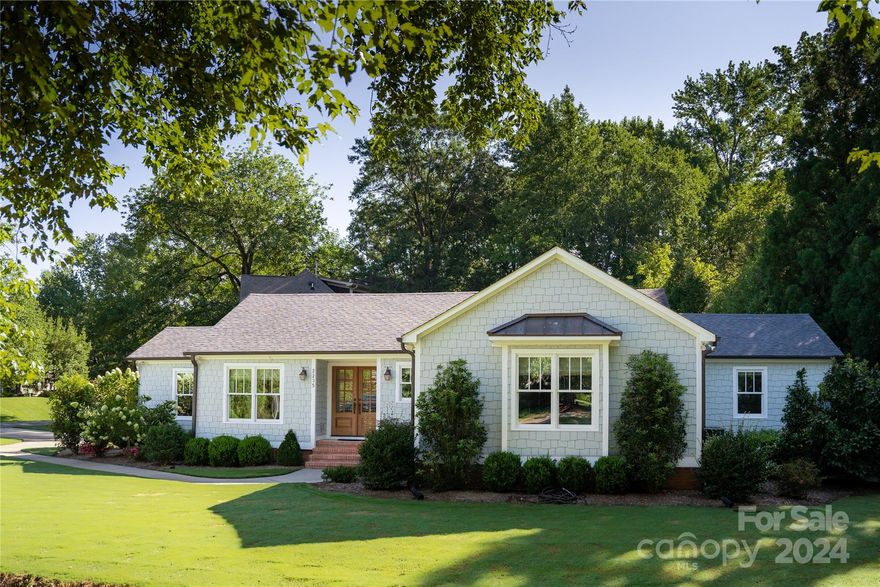 Step into timeless elegance with this beautifully reimagined 1950s ranch, completely transformed in 2020 by Tri-Square Builders, one of Charlotte's top remodeling firms. This home artfully merges mid-century charm with contemporary luxury. The open floor plan showcases a chef’s kitchen with an expansive 4.5' x 9.5' island, olde brick-style backsplash, high-end stainless steel appliances, and stunning quartzite countertops. Shiplap walls and vaulted ceilings add warmth and character to the kitchen and great room, while the office is accentuated by a stained T&G vaulted ceiling. Quality is paramount, with features like Hardi shake siding and foam spray insulation in the exterior walls and entire roof deck, highest end Windsor windows and doors and 16 SEER Trane HVAC.  Outside, enjoy your own private, regulation pickleball court complete with lights and water. Every inch of this home speaks to impeccable craftsmanship and sophisticated design, offering a unique blend of comfort and style.