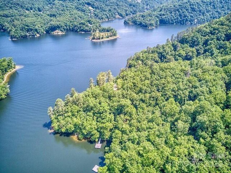 Retreat to the North Carolina mountains at this 2500+ acre one of a kind mountain hideaway. Bear Lake Reserve(BLR) borders Bear Creek Lake, which is large enough for motorized craft, while lot#152 is located on a quiet cove perfect for swimming, paddleboarding, or kayaking. This 1.13 acre lot provides easy lake access to an "easy-build " homesite,which should save thousands in site-prep costs. The lot shares a dock with the adjacent lot and is located on a cul-de-sac, with water,electric, and internet capability on-site.A county septic permit provides for a home with up to 5br. BLR has a full service club,with fine/casual dining,two pools, a hot tub, fitness center, sauna sandy beach and boat rentals. The gated community includes a mountaintop Jack Nicklaus designed golf course, pickleball/tennis courts, hiking trails,and two private trout streams.