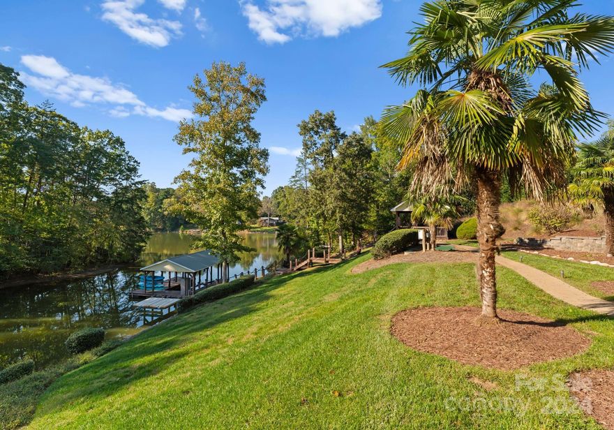 The best of southern style living along the shores of Lake Norman! This private retreat nestled on a large, private cove offering gorgeous water views from almost every room. With over 2,500 sq ft of outdoor terraces, the open-concept layout showcases vaulted ceilings, a cozy fireplace, an updated kitchen with stainless steel appliances and granite island, and 4 spacious bedrooms with dual primary suites. The basement is designed for lake front entertainment, with stained concrete floors, large wet bar, a media room, wine fridge, and workshop / safe room. Natural light floods the home through the floor to ceiling windows offering breathtaking lake views throughout. Outdoors, enjoy a lakefront oasis with expansive balconies, a lakeside gazebo, fountain, and private swimming platform. Additional highlights include a large game room, fire pit, and covered dock. Ideal as a private lakefront home or as an established VRBO investment, reach out for more details!