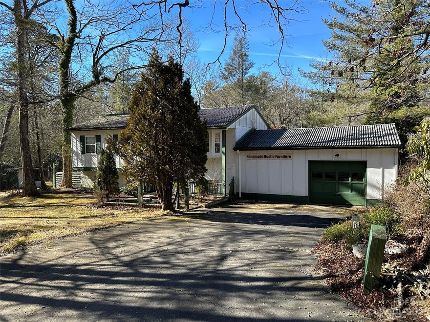 Ideal fixer-upper located in a small neighborhood in Sapphire NC. Convenient to Brevard, Lake Toxaway, Sapphire and Cashiers. Three adjoining lots provide ample space for expansion, a garden or extreme play ground. This split level home has an oversized living/dining area, a galley kitchen, half bath and primary suite on the main level. A family room/office, laundry, two guest rooms and full bath are on the lower. Plenty of outside living with the open upper and covered lower decks. The separate workshop affords diverse opportunity to the worker-bee or handyman and the vacant lot already has an existing well.