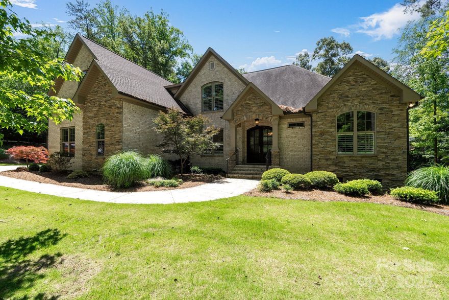 Carolina Country Club - Built in 2017, this stunning custom home is nestled on nearly one acre within one of Spartanburg's most prestigious golf communities. Exquisite and move-in ready, this 4 bedroom 3 1/2 bath home offers over 4,000 sq ft of living space, a main floor owner's suite and an over-sized 3-car garage with EV charger. Surrounded by lush landscaping, you'll enjoy the heated saltwater pool and spa, and you'll be captivated by the serenity of the natural setting. Chef's kitchen and stunning living spaces inside & out. The open and airy layout of this exceptional home creates an atmosphere perfectly suited for elevated entertaining and effortless living. The fabulous owner's suite features a spa-worthy bath, tile shower & 2 walk-in closets. Spoil yourself in the gorgeous freestanding tub or surround yourself with luxury in the tile shower. Media room and 3 guest rooms upstairs. 18-hole championship golf course, 24/7 guard at gated entrance, fitness center, tennis & dining.