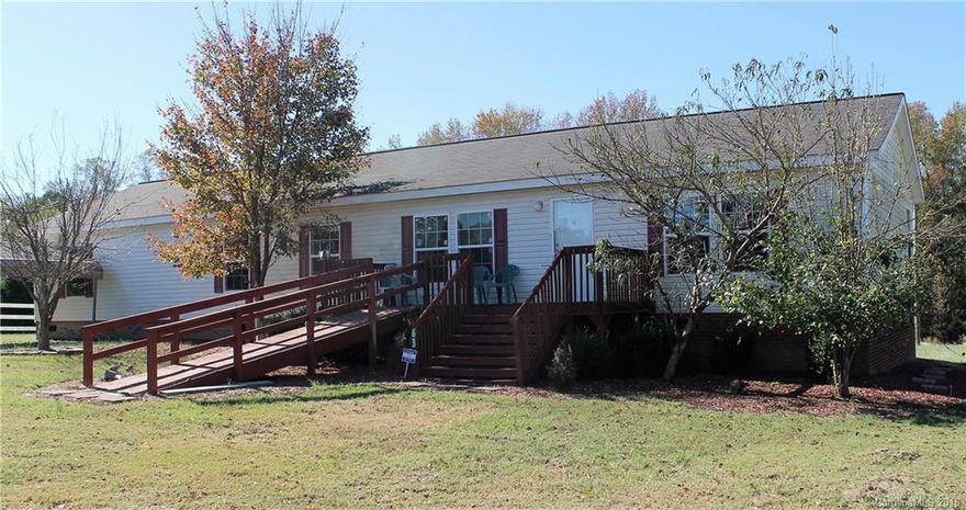 Reduced for fast sale and Open 5 Bedroom and 3 full bath home with split BR floorplan. Great room w/wood burning fireplace. Generous Master bedroom w/large walk-through closet. MasterBath has dual sinks shower and corner garden tub. Roomy kitchen with loads of cabinets has work island, walk-in pantry and desk area. Sliding doors off dining room to backyard.Laminate wood floors throughout home. Yard backs up to wooded area. Large 12x16 storage building & 2 metal carports. Sold as is.