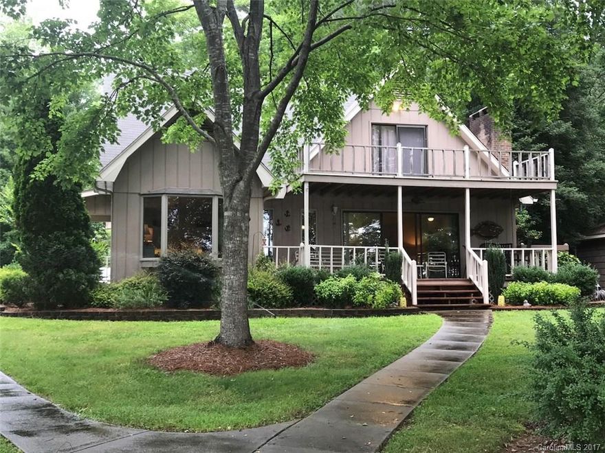 Location, Location, Location! Gorgeous setting! Perfectly flat lot w/ a big view of the cove & main channel. Stunning boathouse w/ big sitting/dining area over the water! 3 bdrms, 2 baths w/ large, open great room w/ fireplace, large breakfast bar & separate dining area. Lots of glass overlooking picturesque covered porch areas, landscaped yard & boathouse! Master on the main & very accessible to the lake with concrete sidewalk, shaded & super nice place to swim & entertain at the boathouse.