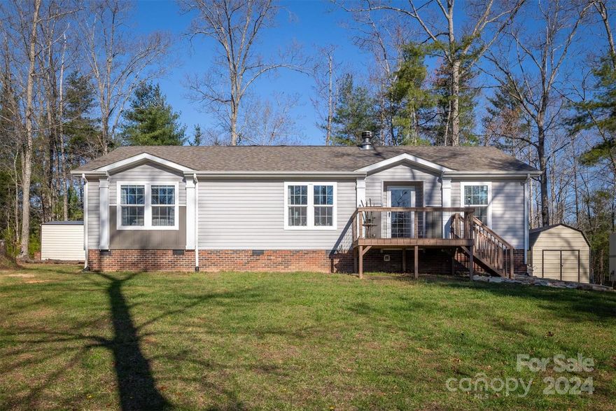 Step outside to your own slice of paradise in this 3 Bedroom 2 Bathroom sanctuary offering a blissful retreat from everyday life.  Tucked away in a wooded private location, this home invites you to relax and enjoy the seclusion of nature.  The open-concept living area welcomes you with warmth and natural light displaying beautiful coffered ceilings and a custom rock wood burning fireplace.  The kitchen displays a large island for prep and dinning as well as stainless appliances including a gas range with a large hood.  This home features a split plan with the primary just off from the kitchen equipped with a dreamy primary bathroom including a large soaker tub, massive walk-in shower, and split dual vanity. Two more ample spaced bedrooms and a full bathroom are located on the opposite side of the home.  A walk through the mudroom also setup for laundry, leads you to the back deck where nature awaits.  Book your showing soon for this amazing property offered at $299,900.