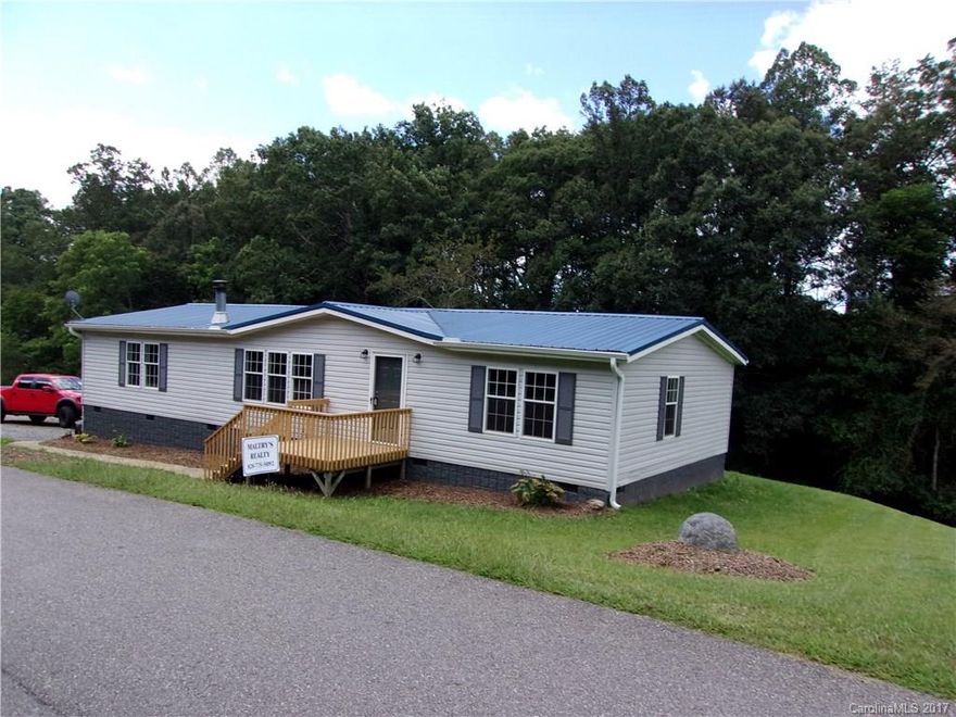 This is an Amazing Find! This home has been renovated inside and out. New Decks on Front and Back. Open Floor plan with a beautiful wood burning Fireplace. New paint,New Flooring including Beautiful Rustic Laminate flooring in Dinning Area and Hallway.  Ceramic tile in kitchen, laundry room and Baths. Tile Shower in Master Bath. New toilets, New Hot water Heater, New Vanity in second Bath. New Appliances. Beautiful Rolling lot. This home will not last Long!