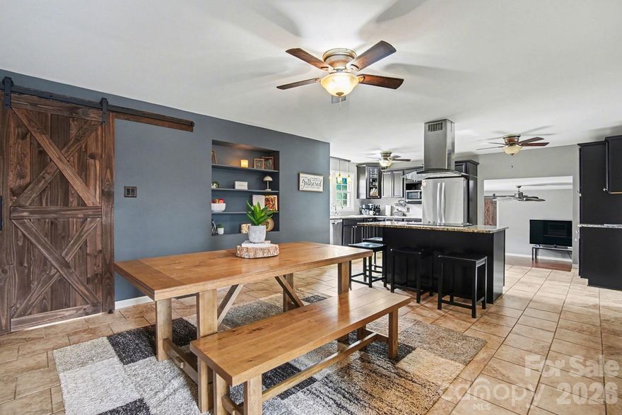 Situated on 1.91 acres, this property offers space, flexibility, and endless potential. The home features a large open-concept layout where the kitchen, living room, and dining area flow seamlessly together—creating the perfect environment for both everyday living and entertaining. The spacious kitchen offers generous counter space and room to gather, while the adjoining living and dining areas provide a warm and inviting atmosphere.
The split-bedroom floor plan offers added privacy, with the primary suite located separately from the additional bedrooms—ideal for comfortable family living or hosting guests.
Outside, the nearly two acres of land provide plenty of room to enjoy the outdoors. An additional building on the property adds exceptional versatility, complete with a bathroom and studio-style apartment type facilities. With acreage, functional living space, and a flexible secondary building, this property presents a rare opportunity to enjoy both comfort and possibilities,  The property has 2 septic tanks - one for the home and one for the additional building  Per previous seller, all rooms networked with Cat-5 computer wire, 2019 - new plumbing in bathrooms; 2020 installed an outside breaker box for a full generator hook up; 2022 new siding, gutter and downspouts and much more.  See this home today!