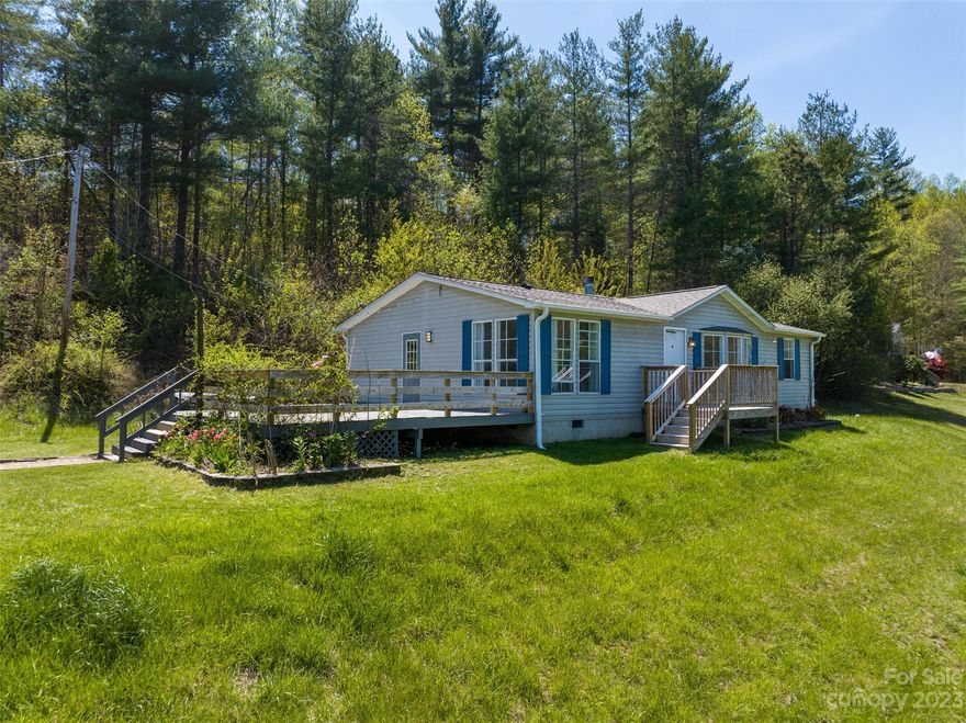 Enjoy long-range views of the countryside from this single-level manufactured home on a concrete block foundation.  The large eat-in kitchen has stainless steel appliances, tile floors, and large windows to let plenty of natural light in.  The great room has a high cathedral ceiling, beautiful laminate hardwood floors, and a gas fireplace to take the chill off on those cool nights. The sellers have replaced the roof and the HVAC system within the past two years so you know this home is good to go! The master bathroom has double vanities and a custom tile walk-in shower. Carpeted bedrooms and walk-in closets. The large side deck side has ample space for entertaining and a working hot tub (needs a new cover, though this handy-man cover works fine!)  The front porch is a great place to sit for a little extra peace and quiet and to enjoy the great views.