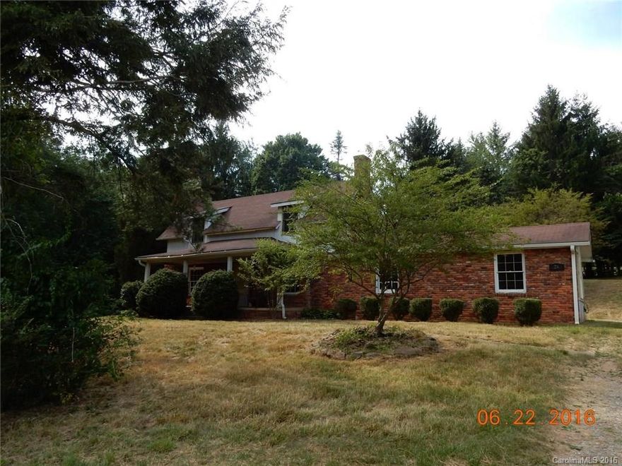 Country home waiting on your TLC, has so much potential.  Features 1 bedroom apartment on main level with private entrance.  Large covered front porch ready for your swing.  Huge level lot with a small creek, nice treed area for escaping the summer heat while listening to the creek.  Easy access and quick 20 min drive to downtown Asheville.