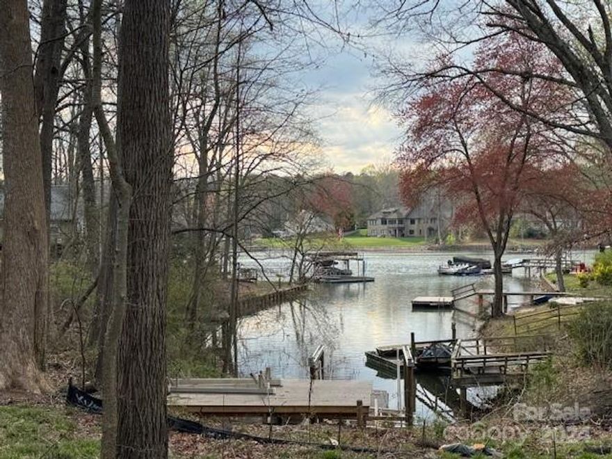 This is it. Your private waterfront lot with serene sunset views right off the popular Brawley School Road. Septic permit has been approved for 4 bedrooms with owners initial custom plan. You can bring your own plan and builder. Private dock platform 12x20 with stairs. There is about 27' of waterfront cove that is rip- raped. The shoreline has been dredged in 2020. Calm cove with fast access to get out of no wake zone area. Short walk to Stutts Marina. Great location close to shops, restaurants and medical. Agent is the co-owner.