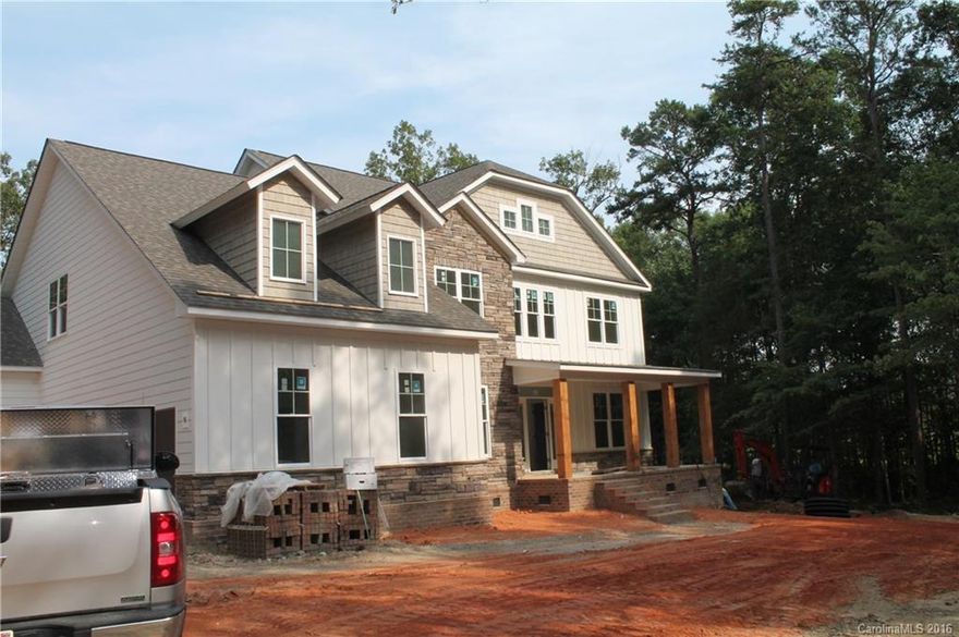 Want it all? Look no further! Over 4 acres, 4 CAR GARAGE with beautiful setting. Fiber cement and stone exterior on a crawl space. Master on the main level with a fabulous master bath, his and her vanity, huge tile shower, plus a huge master closet. Hardwood flooring in main living area and Master bedroom. Fantastic kitchen with Quartz counter tops plus an induction cooktop unit. Oak tread staircase with iron spindles, 2 story grand room with coffered ceiling has all the wow factor!