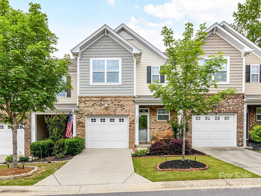 Welcome home to 7325 Overmountain Drive—beautiful, modern, and turnkey in the established community of The Woodlands! This move-in ready 3BR/2.5BA townhome offers timeless craftsmanship and quality in a great area. You'll notice brand new FRESH PAINT throughout, beautiful hardwood floors on the main level, newer carpet upstairs, a newer hot water heater, and upgraded garage storage. Enjoy an open-concept layout with granite kitchen, gas range, island seating, and pantry. The dining area flows into a bright great room with large windows and a cozy gas fireplace. Upstairs, the massive owner’s suite features a spacious walk-in closet and spa-like bath with soaking tub and separate shower. Two more bedrooms, a full bath, and laundry complete the upper level. Relax on the private fenced patio. HOA includes lawn care, roofing, exterior maintenance, power washing, pool, clubhouse, and more. Minutes to Lake Wylie, shopping, dining, and entertainment—superior construction at a great value!