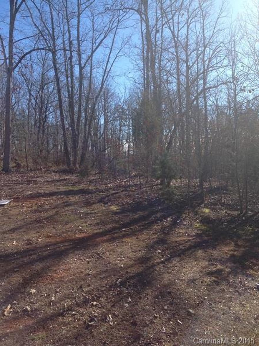 Beautiful .88 acre wooded lot located in very nice manufactured home community with lighted streets.  Only manufactured homes allowed.  No city taxes.