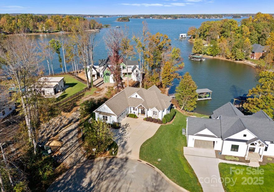 Nestled on the Western Shore of Lake Norman, this luxury custom waterfront home offers an unparalleled living experience. Boasting 4,309 square feet of exquisite living space, this stunning residence features 4 beds, 3.5 baths, and a beautifully finished lower level. Discover a thoughtfully designed floor plan with ample natural light and beautiful main channel views. The gourmet kitchen is a chef's dream, complete with high-end appliances, custom cabinetry, and a spacious island perfect for entertaining. The inviting living room features a cozy fireplace and opens up to a deck overlooking the serene water. The primary suite is a peaceful retreat featuring a spa-like ensuite bathroom and dual closets. 3 additional bedrooms provide plenty of room for guests or family. Outside, the tiered yard leads down to the water's edge, where you can relax on the dock or take a leisurely boat ride on the lake. This waterfront home offers the perfect blend of luxury and relaxation.
