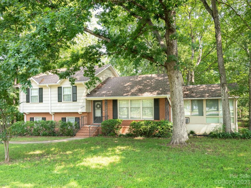 Beautiful split-level retreat with private backyard conveniently located in Olde Providence close to EVERYTHING that the Ballantyne area has to offer. UPDATES include: New HVAC (2016 & 2020), SS appliances, vinyl plank flooring, kitchen backsplash, & interior paint. Welcome home into bright formal living room w/ original hardwood floors leading to spacious kitchen and formal dining room. Beautiful enclosed glass sunroom with privacy blinds heated and cooled w/ jacuzzi to enjoy every season. Upstairs find oversized primary bedroom w/ attached full bath. 2 additional bedrooms (or home office) plus full bath. Downstairs family room/den area w/ fireplace plus full bedroom & bathroom. Fully fenced in backyard with large patio and pergola are perfect for entertaining and relaxing! The detached carport has extra storage/workshop area. Conveniently located just minutes to Ballantyne, SouthPark, and easy access to I-485. Close to shopping, dining and entertainment at Colony Place and Arboretum.