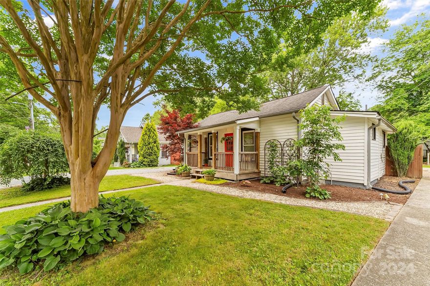 Sweet home that boasts real hardwood floors, granite countertops, and a location just a quick stroll from many attractions and activities. It's perfectly situated within blocks of downtown shops and restaurants, parks and activity centers, the new Trail Side Brewing, coffee shop, and the much anticipated Ecusta Trail. With its excellent floor plan, this home allows for ample open living and dining/flex space and two bedrooms, each with their own full bath. The lovely covered front porch is perfect for sipping your morning coffee and the large, tree lined back yard beckons you to enjoy your evenings there. This private fenced space is complete with a rear patio for entertaining and fire pit, perfect for a relaxing evening at home after a day of shopping and enjoying all downtown Hendersonville has to offer. The backyard also has a cute storage shed barn with a good size deck  attached.