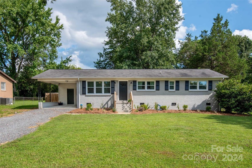 Tucked away, completely renovated, & just minutes from access to I-77, you’ll find this adorable 3 bedroom, 2 bath ranch. This home offers an updated kitchen w/stainless steel appliances, granite countertops, island w/ bar seating, soft close drawers, & much desired cabinet space. Primary bedroom includes ensuite & 3 closets!  The open layout provides great flow for entertaining, while a newly added back door provides easy access to outdoor living. A 6’ privacy fence encloses a flat backyard that houses a cute patio ready for a firepit, perfect for hosting friends and family this fall. Great natural lighting throughout the home. Use the covered carport to stay dry on those rainy days! Want to add your own touch? The laundry area has a fun Board and Batten wall, along with tongue and groove ceiling, ready for new buyer personalization! Nearby parks include Hargett & Cherry. Super close proximity to Downtown Rock Hill, Winthrop University, grocery stores, restaurants, & shopping!
