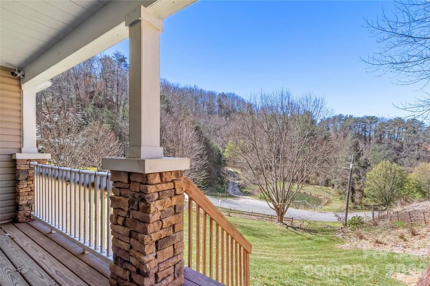 Back on the market, Buyer's financing fell through!  Tucked away to capture peaceful mountain views, this spacious doublewide offers the perfect blend of privacy, comfort, and convenience. Located in the desirable Newfound area, you’ll enjoy easy access to both Asheville and Waynesville, with quick paved access right off I-40.
Inside, the inviting layout features a bright and open living space anchored by a cozy gas log fireplace, perfect for relaxing evenings at home. The kitchen includes a functional island and flows seamlessly into a charming dining area highlighted by a wall of windows overlooking a serene neighboring pond, creating a truly picturesque setting.
The thoughtfully designed split-bedroom floor plan provides privacy, with an oversized primary suite offering a comfortable retreat, large tub, double vanity and stand-up shower. A convenient laundry/mudroom sits just steps from the metal garage/workshop, making everyday living even more practical.
Outside, the property continues to impress with a versatile metal garage featuring three garage doors—ideal for hobbies, storage, or workspace needs. Concrete patio in the back makes this home perfect for both relaxing and entertaining!
Some livestock fencing in place and a platform where goats used to be kept.  Whether you’re seeking a full-time residence or a mountain getaway, this property delivers space, functionality, and scenic charm in a prime location.