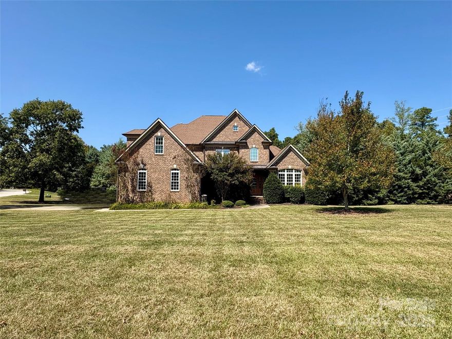 Nestled on a private 1.96-acre corner lot, this custom full-brick home has all the features you have been searching for! Grand 2-story entry welcomes you inside, leading to beautiful hardwood floors throughout the main level. There is a formal dining room for gatherings plus a dedicated office space. A spacious great room sits at the heart of the home, creating an effortless flow for entertaining. The white kitchen is a chef’s dream, complete w/quartz countertops, a large island & stainless steel farmhouse sink. The main-level primary suite is a true retreat, featuring vaulted ceiling, abundant natural light, a renovated bath w/granite & custom walk-in closet. Front & back staircases allow easy access to upper level w/three generous BRs, a bonus room, plus cozy loft. Outside you'll find a covered back porch overlooking a sprawling backyard, complete w/a firepit & tree-lined yard. Three car garage. Located in an exclusive Lake Wylie waterfront community with the flexibility of no HOA. Hardwood floors to be refinished with color of buyer choice with acceptable offer (ask LA for more details).