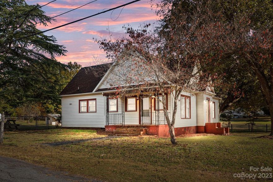 This  farmhouse-style house is situated on an expansive flat lot. Minutes off I85 and close to Atrium Health & Downtown Concord/Kannapolis. The home has high ceilings, functional layout with large rooms and lots of natural light. There are hardwood floors in oversized living room and bedrooms. The updated full bathroom  has a  pedestal sink, ceramic tile flooring and large re-glazed tub.  The eat-in kitchen is full of big cupboards, lots counter space, and unique built in shelves. There is a  wall oven, built-in cooktop, portable dishwasher and S/S refrigerator. Right off the kitchen is a flex space room with built-ins, making it perfect to use as a study, den or playroom. The mud/laundry room is large with lots of storage. There is a screened in back porch, side porch, a two story wired  storage building with tool shed, and another wired outbuilding. The home has new roof in 2019, HVAC in 2022, Updated Plumbing and 200 amp. Electrical. Don't miss this one. Make appt. today!
