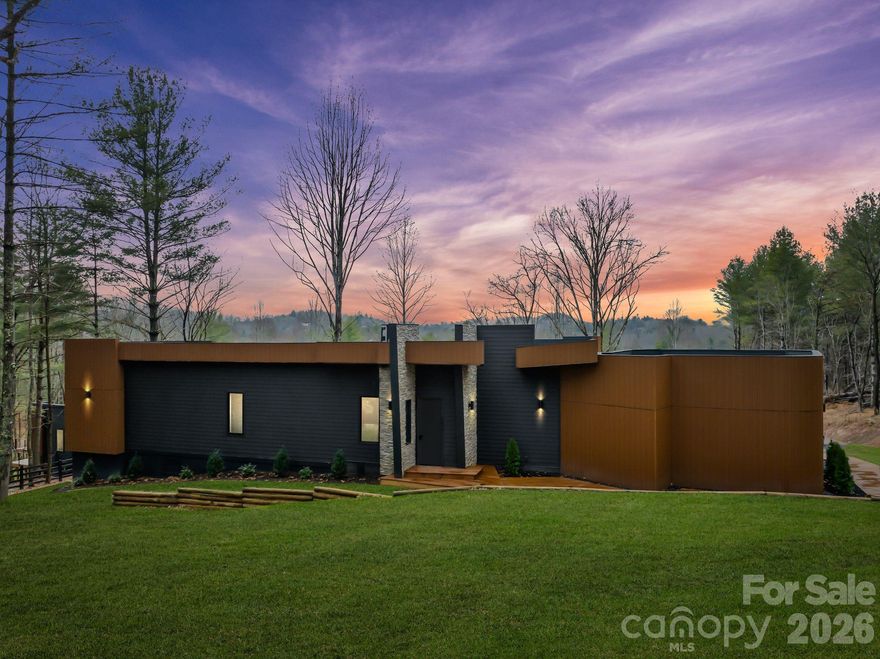 New construction and new to the market! Live Inspired at Skönt at Mills River! Welcome to a rare opportunity to own a truly distinctive modern retreat, tucked within an exclusive five-home enclave in Mills River. Designed to feel both intentional and serene, this single-level residence blends clean European architecture with the quiet beauty of the North Carolina mountains—creating a home that lives like a private escape. At the center of the home, a custom-designed kitchen featuring Italian SMEG appliances sets the tone for thoughtful, design-forward living. Expansive windows and seamless indoor-outdoor flow fill the home with natural light, while an impressive 1,100-square-foot deck becomes an extension of everyday life—perfect for morning coffee, afternoon relaxation, and evenings surrounded by nature. Each of the three ensuite bedrooms offers privacy and comfort, with direct access to the deck and a sense of retreat in every space. Carefully curated finishes and architectural details elevate the home throughout, striking a balance between modern sophistication and effortless livability. Skönt at Mills River is more than a home—it’s a lifestyle defined by simplicity, intention, and calm. This is your opportunity to experience modern mountain living at its most refined.