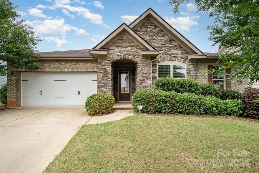 Welcome to this stunning ranch home nestled on a spacious lot in one of Fort Mill's most coveted neighborhoods. As you approach the house, you'll be captivated by its attractive curb appeal. Step inside to a welcoming foyer that leads to a beautifully upgraded interior, featuring gorgeous hardwood flooring. The open concept kitchen and oversized island are perfect for entertaining, allowing a seamless flow from the living space to the backyard stone patio. Cozy up near one of the fireplaces on chilly evenings. Ample storage can be found throughout the home for added convenience. The owner's suite boasts a generous closet and luxurious jacuzzi tub for ultimate relaxation. Take a short stroll to enjoy Catawba River access, the neighborhood clubhouse, and pool for endless enjoyment. Don't miss your chance to call this property your home!