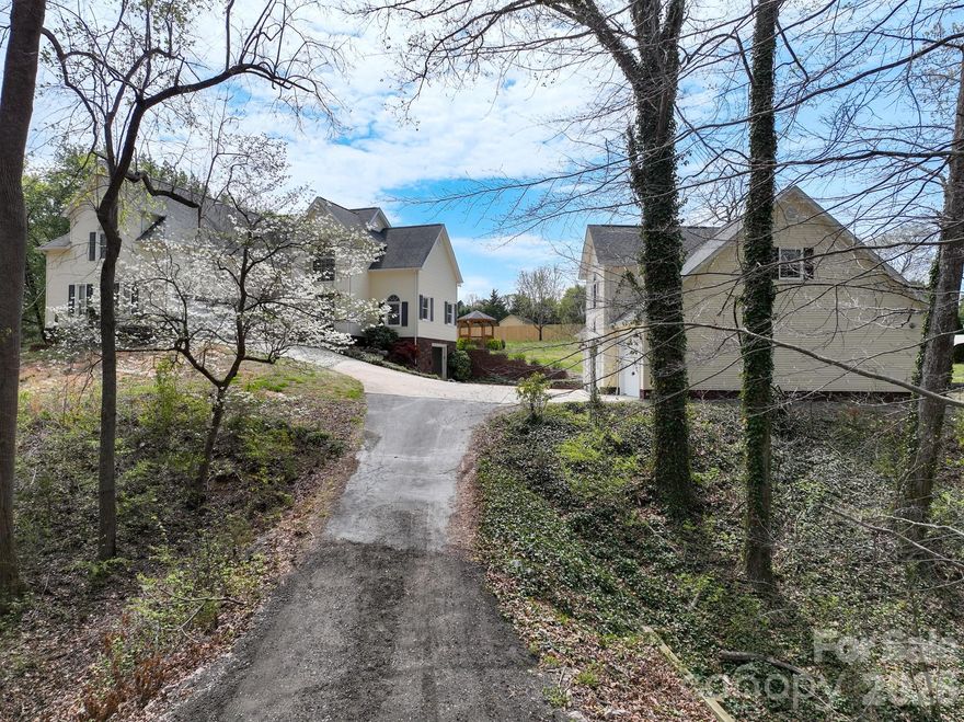 This home is such a rare find in this area! As you drive up the driveway to this beautiful home on the hill, you will be welcomed by beautiful budding trees and a stunning water feature. Having a get-together? You will find plenty of parking with the 2-car attached garage, 3-bay detached garage, 1-bay basement garage, plus room for more parking in the driveway. There is also a 2-car carport, great for storing lawn equipment or tractor. Have an RV? No problem! There is also a detached RV Carport.
As you enter through the beautiful front door of this home, your eyes will instantly be drawn to the stunning staircase that leads up to the primary ensuite and the other bedrooms.  To the right, you will see the living room that features a beautiful brick fireplace, great for those cold winter nights.  Straight ahead is an open room that can be used for a formal dining room, office space, or a flex space.  Turning to the left, you will enter into the open kitchen area that features a large open island that has storage on both sides. All of the stainless steel appliances are included!  There is a large open area that leads from the kitchen that can be used for a breakfast area plus an additional family room, sitting area, or dining area. This would be great for those who love to hang out in the kitchen while cooking and entertaining.  There is a half-bath located on the main floor, plus the laundry/mud room that leads to the attached 2-car garage.  There is an interior access to the basement from the main level as well.  
As you go upstairs, the primary ensuite is located directly at the top of the staircase, featuring double doors that lead into the huge primary suite. The suite features 2 separate closet areas on either side of the entry to the gorgous primary bath.  You can enjoy soaking in the freestanding tub or take a shower in the walk in shower featuring beautiful tile and glass.  There are 2 separate vanities and a separate water closet which offer more privacy.  You will simply be amazed at the beauty of the tile in this spa-like bath.
Also on the upper level, you will follow the hallway around to 2 secondary bedrooms, a full-bath, and a huge bonus room, great for an office, workout room, playroom, recreation room, etc.  Need storage? This home did not waste any square footage and includes so much storage area.
Outside from the kitchen area through the glass sliding doors, you enter onto the concrete patio that features an outdoor kitchen area and bar. There is also a hottub and firepit located on the patio.  This is a great entertaining area.  The backyard is spacious and actually connects to the prior street on Crestwood, giving you access to drive across the yard to park your RV in the RV Carport located beside the home.  There is also plenty of room for a pool.  This yard also features a small greenhouse that could use some TLC and a detached 2-car carport located behind the detached garage.
If you are a car enthusiast, this property may be for you! The detached 3-bay garage is oversized and features a bonus room and half-bath upstairs, great for a game room or enjoying time with friends and family.  There are so many options with this garage!
If you are looking for a rare gem hidden outside of the Kannapolis city limits, you've got to check out this home. You will be amazed!